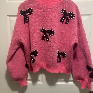 Pink Sweater with Bow Accents and Pearls